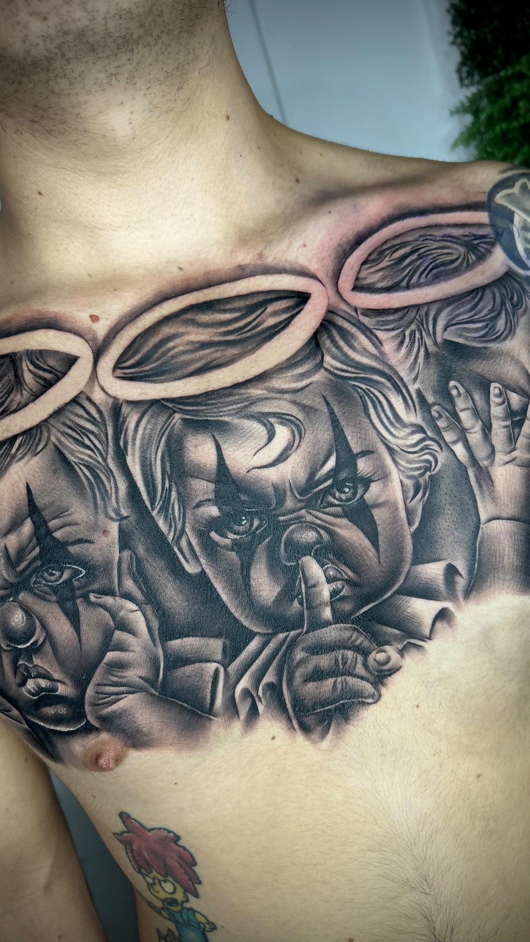 Angelic Clown Trio Chest Tattoo