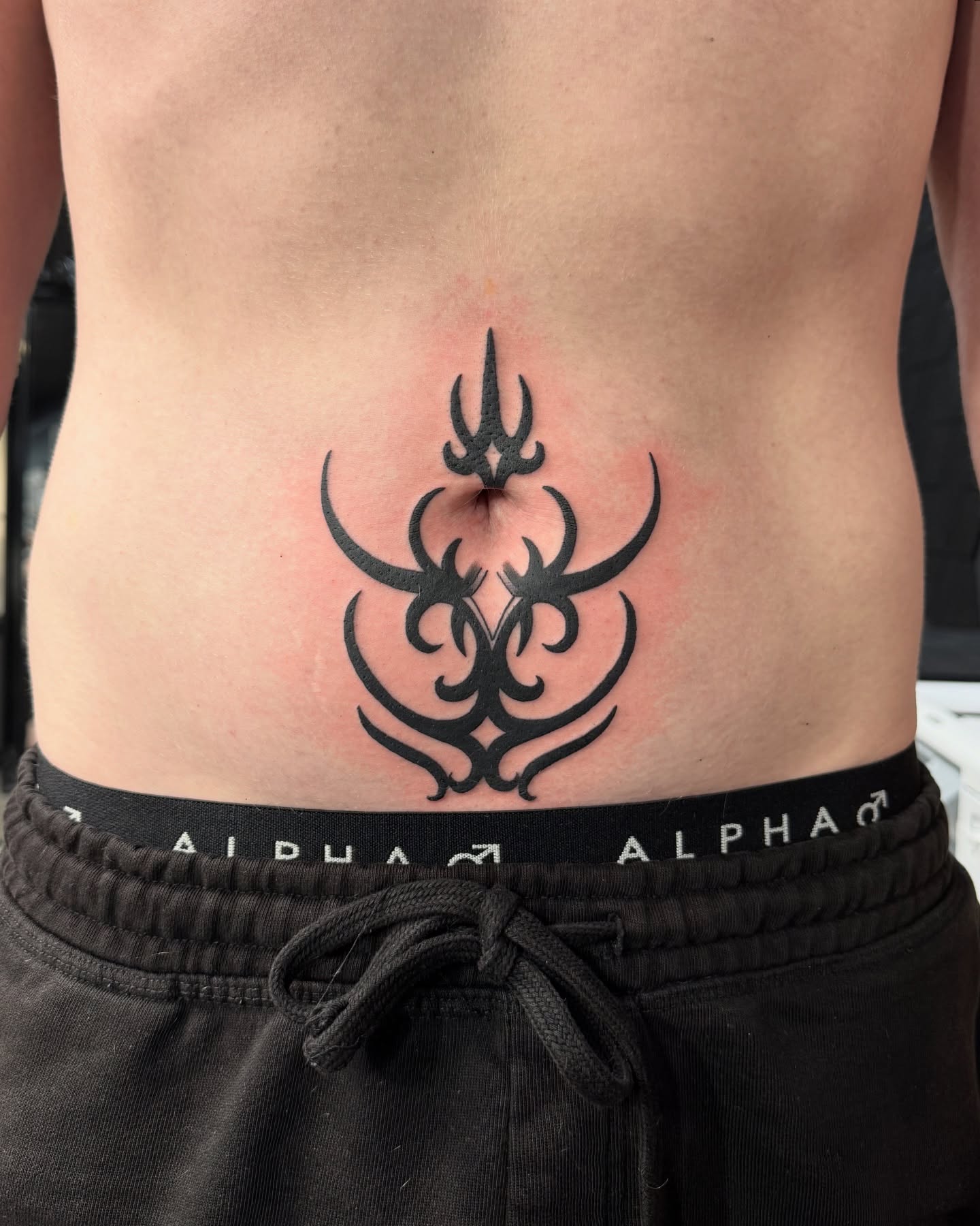 Bold Tribal Stomach Tattoo