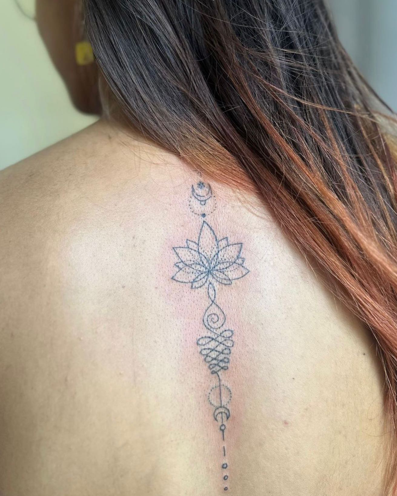 Delicate Lotus Back Tattoo