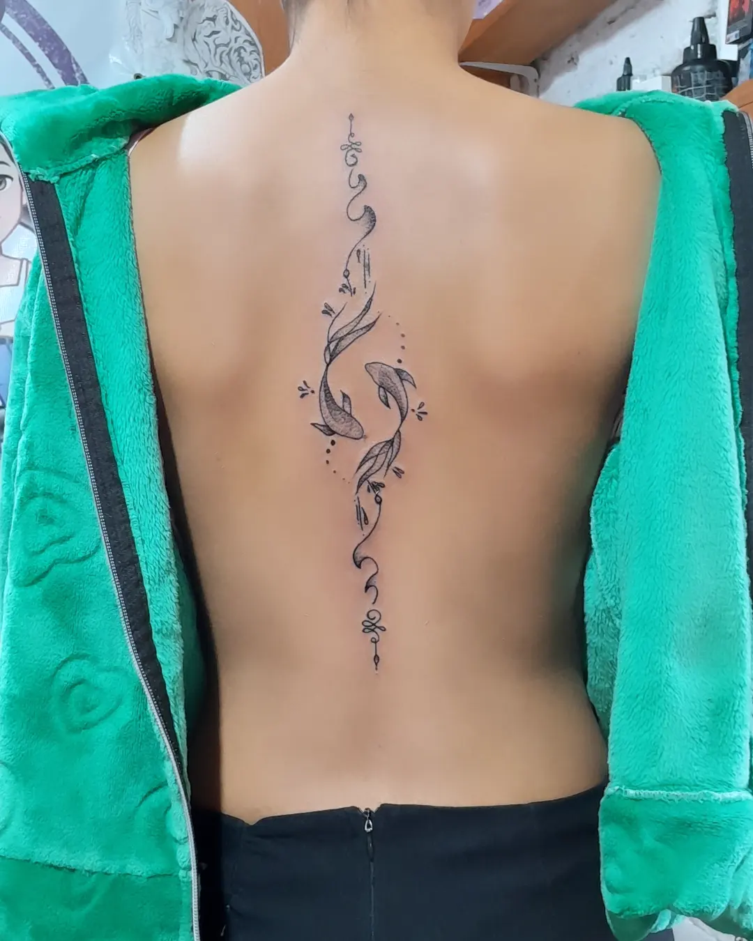 Elegant Koi Spine Tattoo