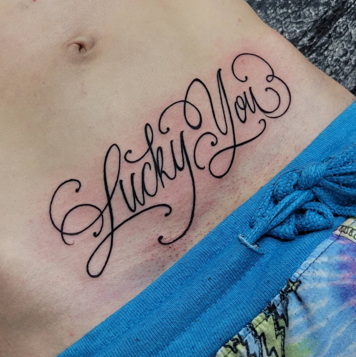 Elegant Script Bottom Stomach Tattoo
