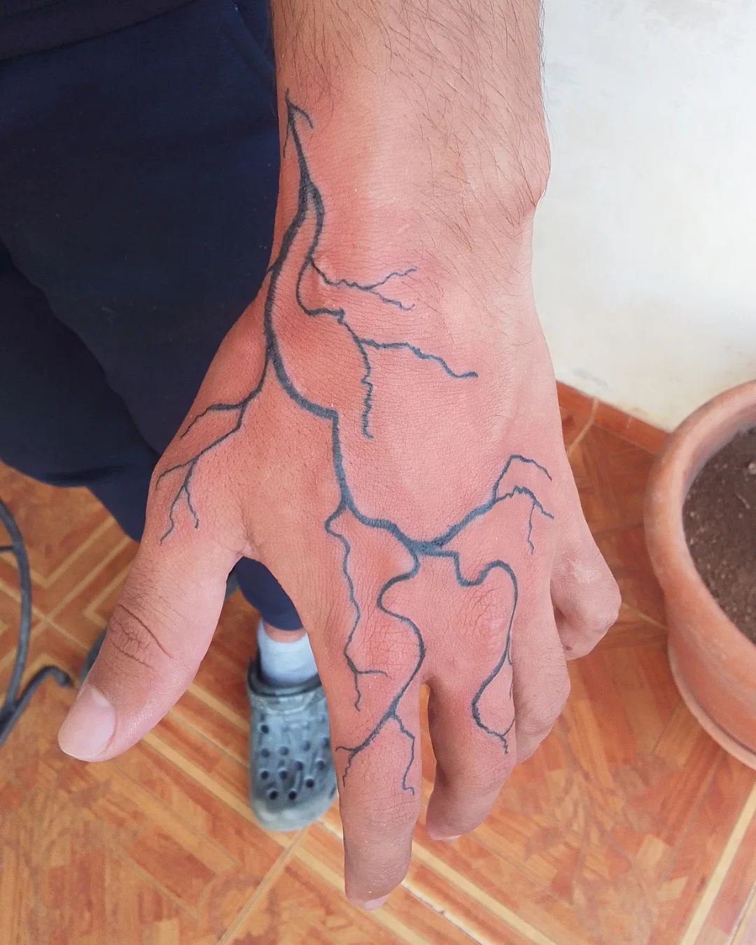 Flow Line Hand Tattoo
