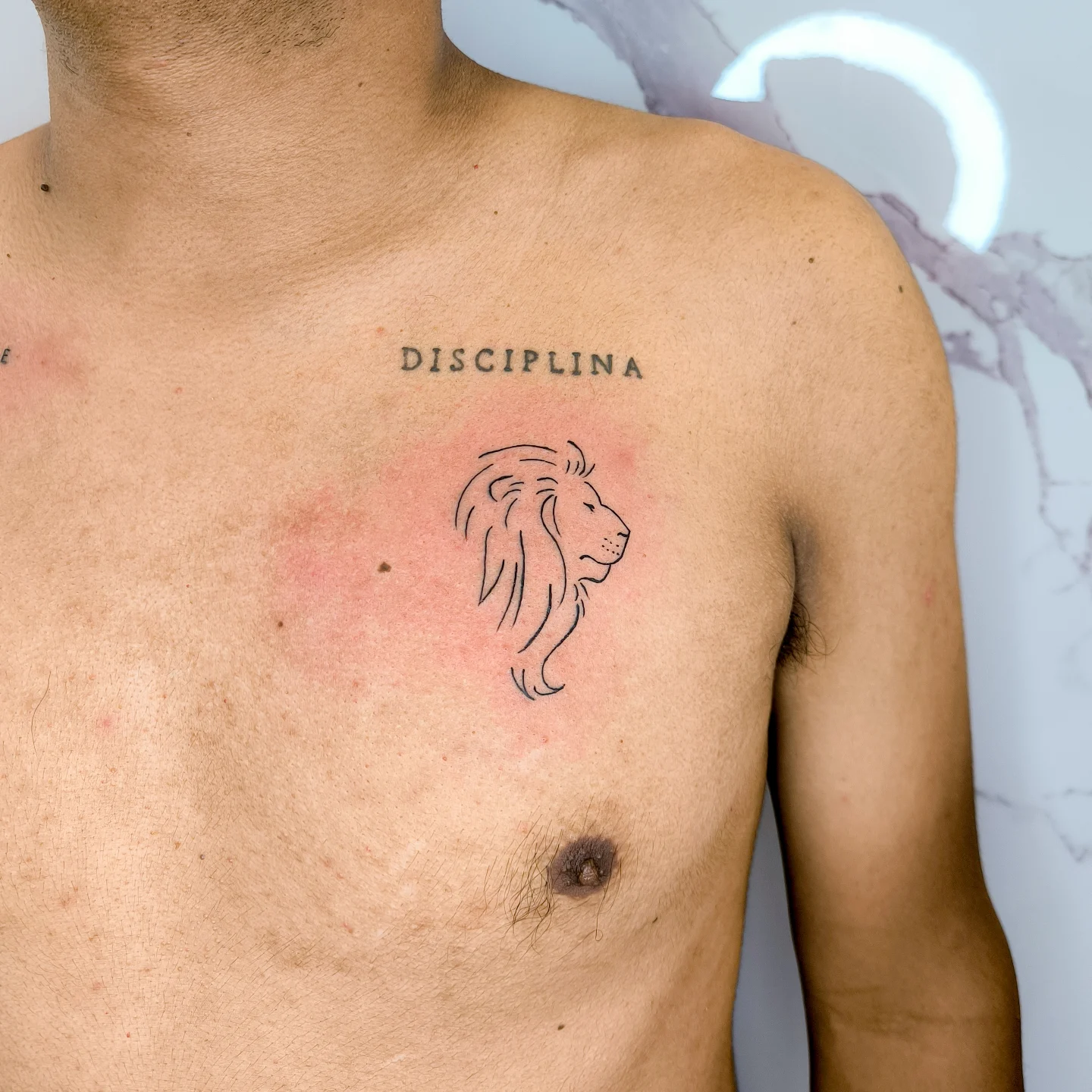 Minimalist Lion Chest Tattoo