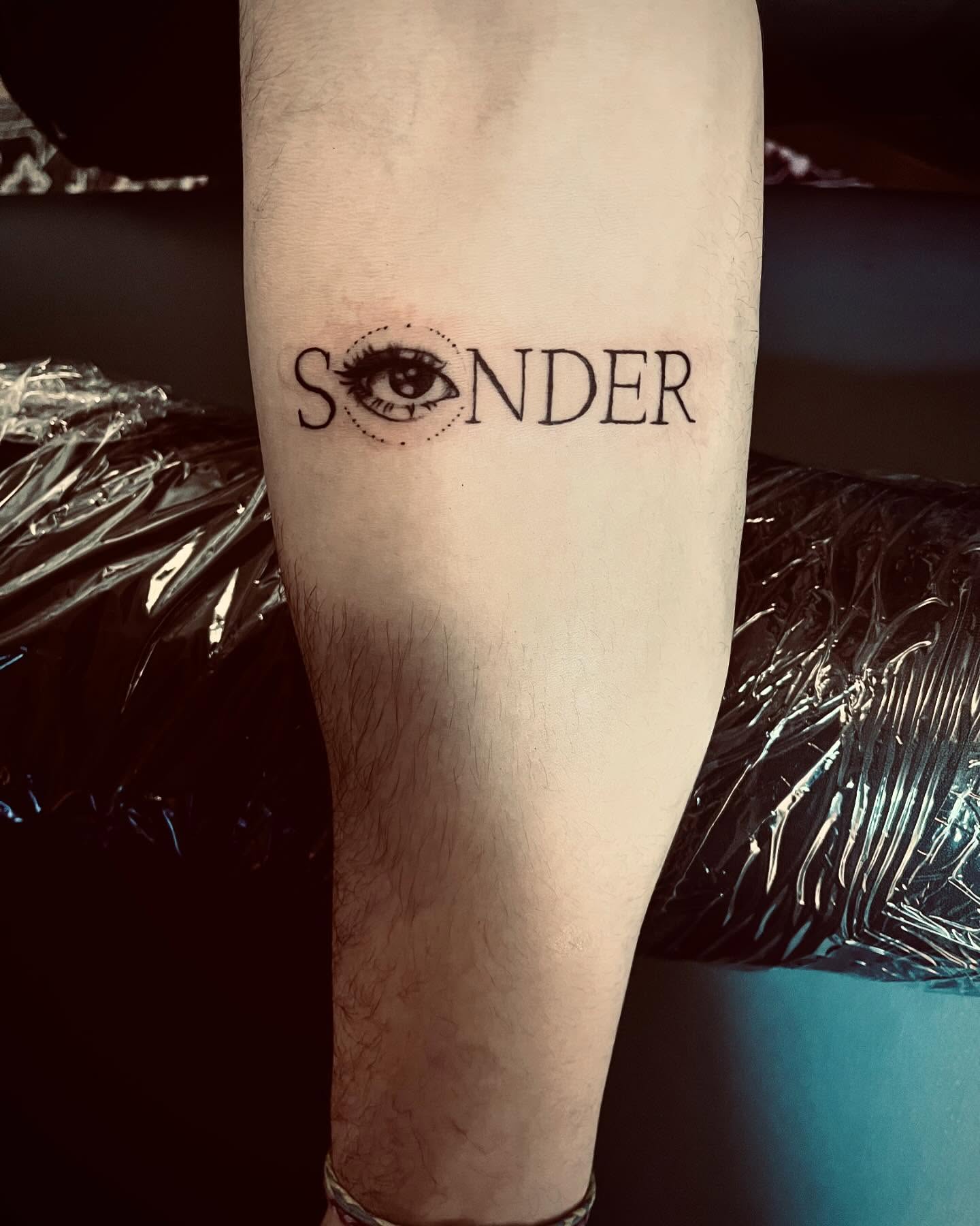 Sonder Eye Word Tattoo