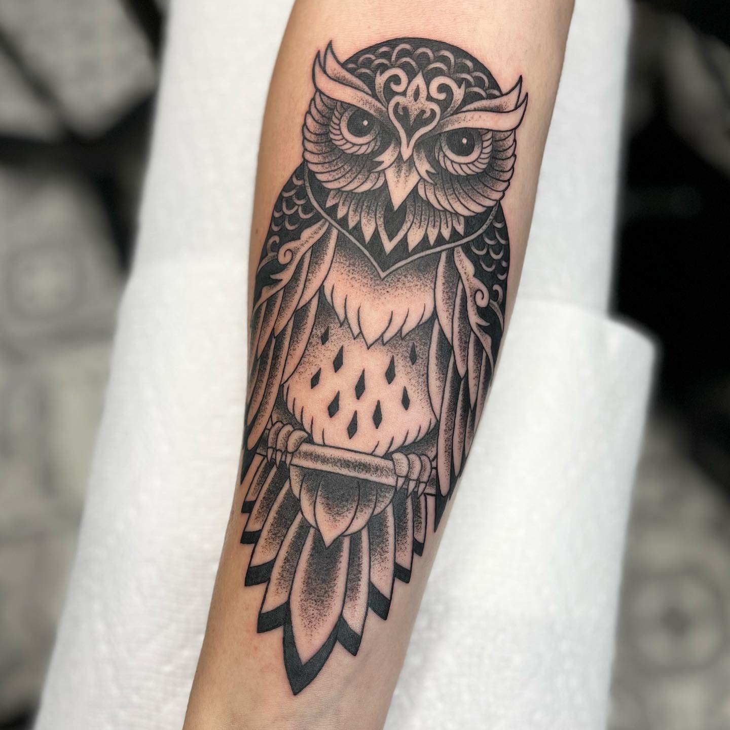 Stylized Owl Forearm Tattoo